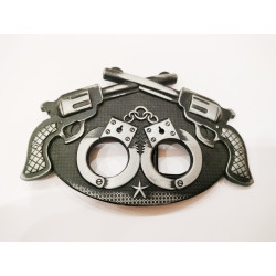 Belt buckle in the shape of handcuffs and guns